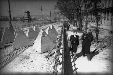 Dunakorzó, tankakadályok a villamossíneken, háttérben a lerombolt Széchenyi Lánchíd. Jobbra a Dunapalota (egykor Grand Hotel Ritz), 1945. Forrás: Fortepan / Vörös Hadsereg